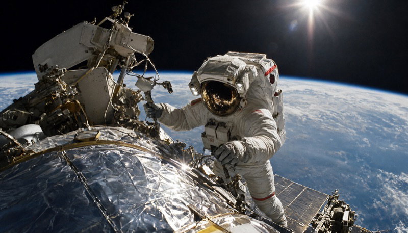 An astronaut on a spacecraft above the Earth